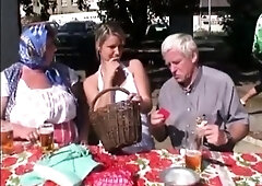 Buxom teen joins a mature couple for a threesome outdoors