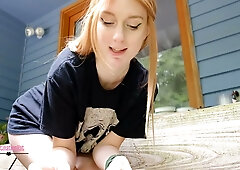 Blonde on a wooden porch spreads her legs to expose her shaved pussy