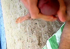 Homosexual milks his giant lollipop and jizzes at the beach in public