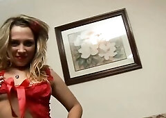 A curvy golden-haired with a red hair bend disrobes and works a glass toy into her snatch on a patterned sofa.