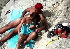 Couple shares mutual handjobs to orgasm on a rocky public beach