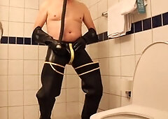 Rubbergloved draining in the motel bathroom wearing waders