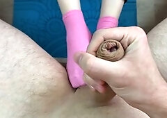 Sporty girl in pink socks does exercises on the mat and gives a footjob to her trainer