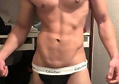 bodybuilder posing in a taut panty