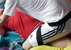 2 soccer youngsters toying in a sofa