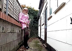 Crossdressing Shemale Gina Outdoors in Pink PVC and Pissing