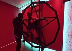 Strapped to a Satanic cross and orgasms with a magic wand, while she gets electric shock that makes sparks fly.