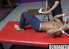 Kaden Roads slaps captive with flogger before jerking his cock