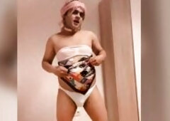 Sissy whore Femme Sandy undresses and show her small locked clitty and dances.