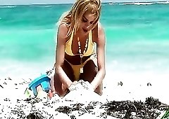 Buxom shemale Karla Carrillo plays with her boner on beach