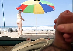 matured tourists have extreme outdoor handsjob on the beach.