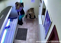 Blonde woman masturbates on a sunbed in a solarium, caught by a hidden camera