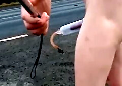 Bare with and out of jock pump at side of busy road