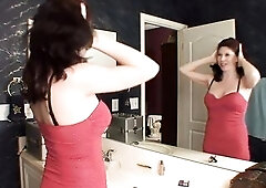 Shapely cougar slides off her red evening gown and pleasures her snatch