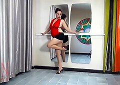 Regina Noir dances sensually in a tight red top and short black skirt during a private behind-the-scenes session