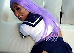 A purple-haired teenager eighteen with large baps poses in