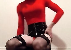 Sissy clothed in a pencil latex petticoat and constricted red shirt edges for u during the time that a dildo is up her butt
