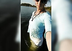 Trans hotty swimming in the lake in raiment blue blouse and white-milk panties.