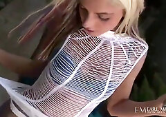 Blonde Christine Alexis strips down to blue lace panties in a sunlit garden