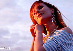 Jeny Smith poses in fishnet pantyhose in a public photoshoot