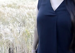 South Asian British woman stands on a grassy path in a quiet public park