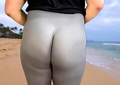 Muscular man with perfect ass jogging on crowded beach