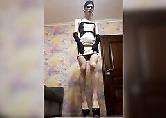 A crossdresser positions and smokes in a costume.