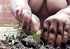 A fat, hot evangelical woman planting vegetables, showing off her heavy tits outdoors to her neighbors.
