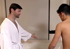 Tattooed parent and sporty uber-cute lad bathing together