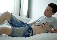 Platinum-blonde twunk Aaron A strokes to a cumshot on his sofa