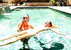 It begins in the pool with moist kisses and bikinis pulled aside. Inside they finish what they started: legs widen on the couch, tongues working, fing