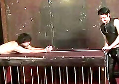 Submissive being flagellated by master