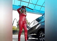 At the car washing station in red vinyl outfit