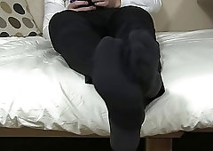 Handsome businessman massages his feet