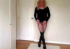Little black dress with fishnets and latex boots