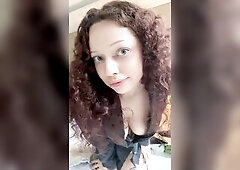 Hairy-haired cutie leans forward, cleavage on display ?