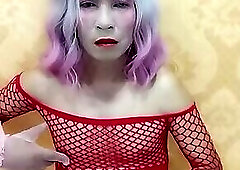 Oanh Le transgender wearing pornographic netting stockings playing with a fake can