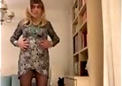 Beautiful blonde Spanish trans girl poses in high red heels and lingerie with a sexy dress