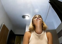 Super sexy small golden-haired cheerleader wears a short miniskirt with a watch throughout top to show her breasts