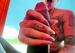 Cum loving tattooed MILF sucks off big black cock outdoors