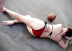 Good lady at lonely nudist beach. Red swimsuit. Red bikini. Coconut