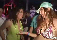 Curvy bikini dancer commands the crowd at a chaotic neon-lit party concert