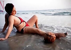 Worthwhile lady at lonely nudist beach. Red swimsuit. Red bikini. Coconut