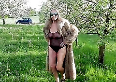 A aged woman is walking around outside in a watch-throughout bodysuit!