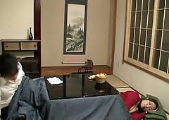 Young Japanese couple explores passion under the blanket in a traditional room