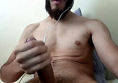 Horny Latino guy jerking off his massive cock until he cums hard