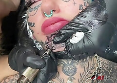 Australian bombshell Amber Luke shows off her fresh chin tattoo