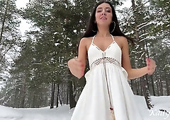 Long-haired brunette takes cumshot on face during doggy style in snowy forest