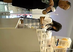 Asian woman in floral dress caught on camera with upskirt exposure in public store