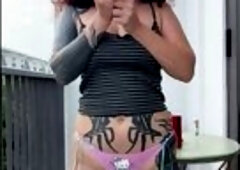Tattooed haunches widen slightly as that babe undoes her top ?